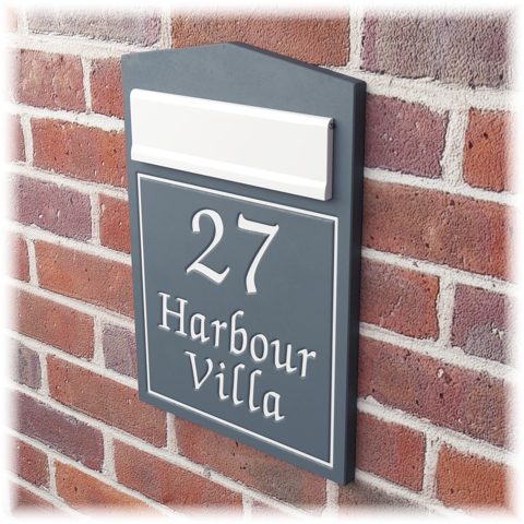 Slate letterbox in a brick wall