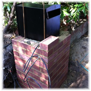 Stamford postbox being fitted into a brick pier