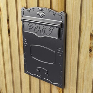 Rear retrieval mailbox fitted into a wooden fence